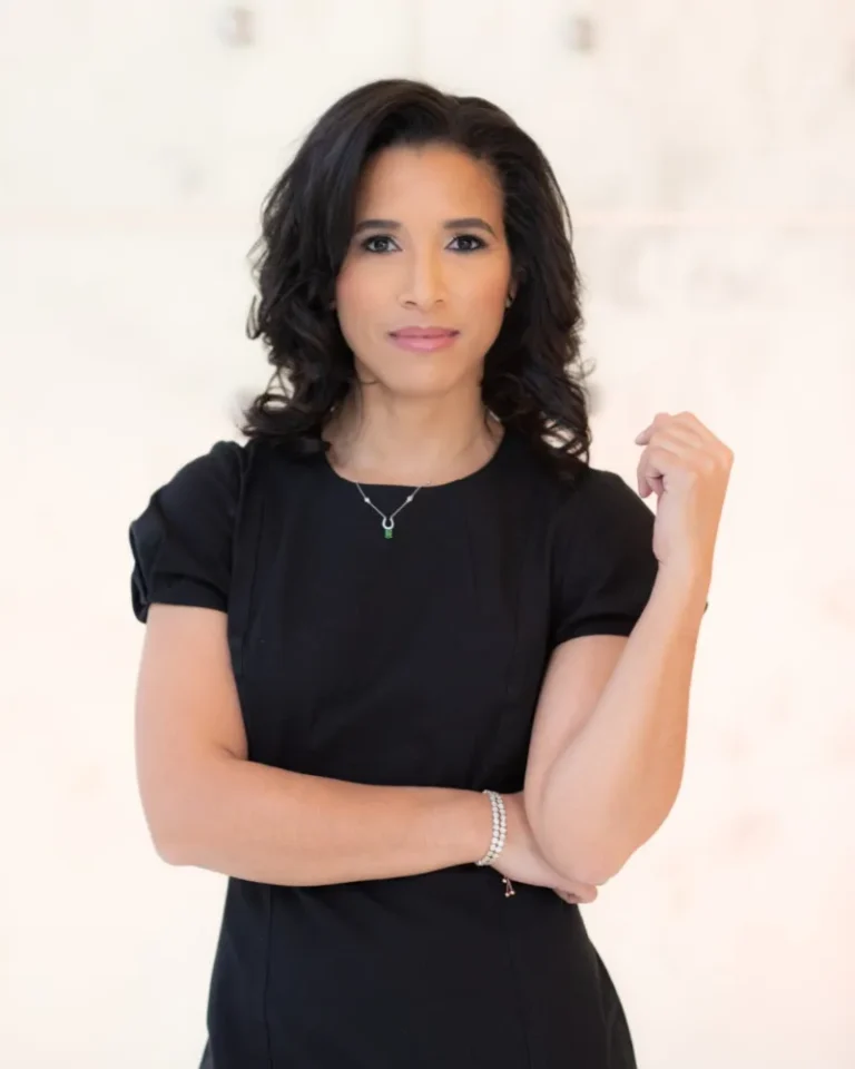 professional photo woman with dark long hair in black professional dress looking at camera